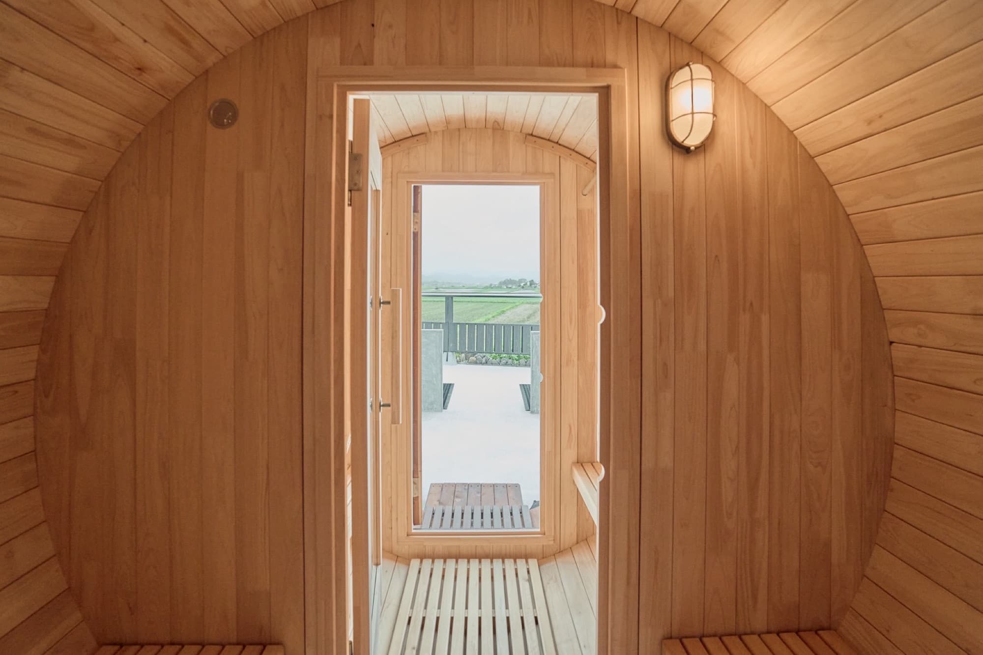 Inside the barrel sauna, looking out at the rice fields
