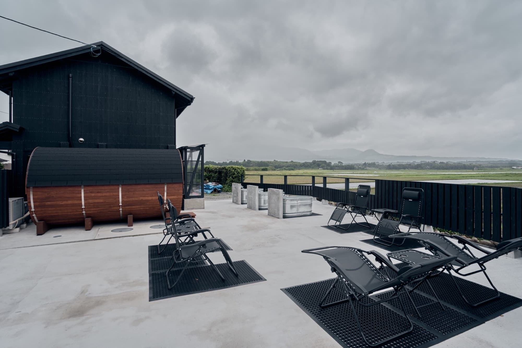 The sauna terrace with loungers facing the rice fields and mountains